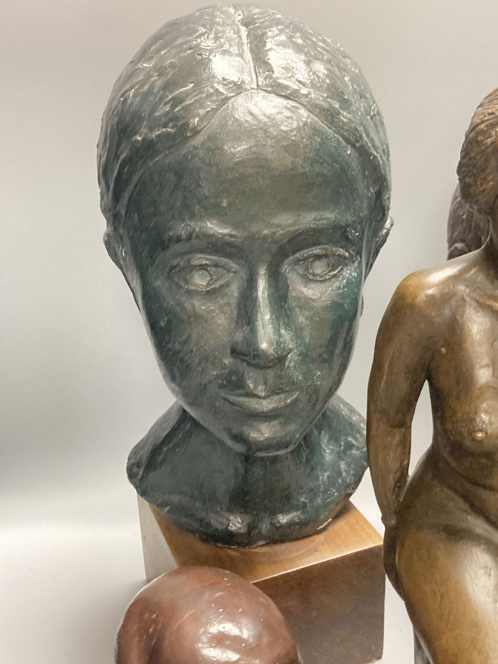 Five bronzed plaster and resin figures / busts, seated lady 39cm